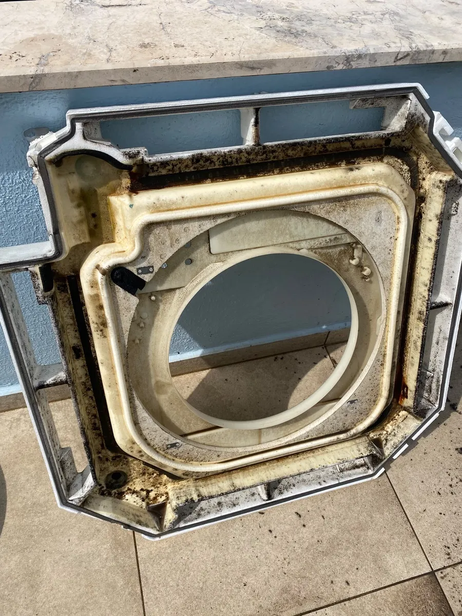 Dirt visible on a removed cassette unit component before cleaning