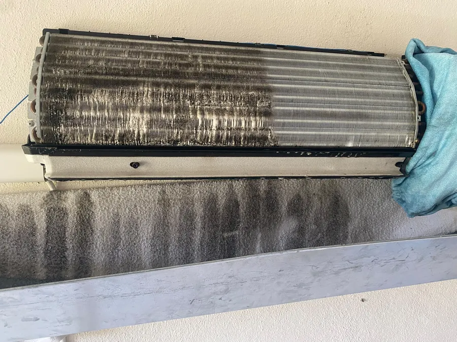 Partially cleaned indoor unit during air conditioner maintenance